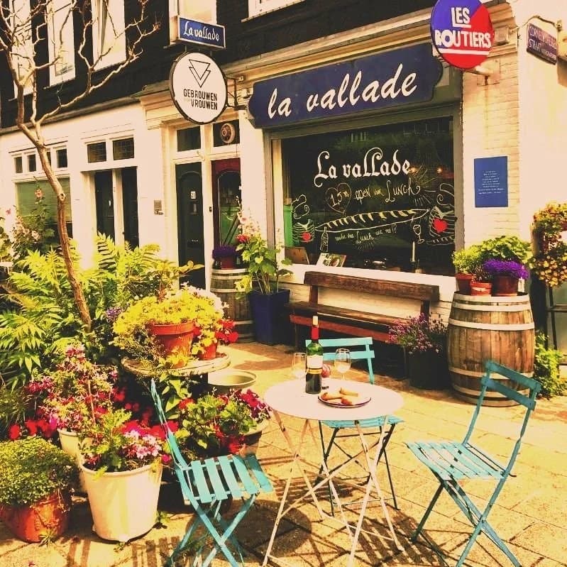 La Vallade outdoor cafe tables and plants storefront